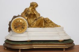 A 19th Century mantel clock surmounted with classical gilt bronze female figure, on white marble