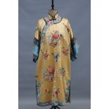 A Chinese embroidered yellow silk robe and matching pantaloons, floral sprays with vase and symbol