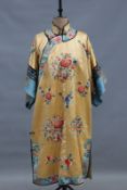 A Chinese embroidered yellow silk robe and matching pantaloons, floral sprays with vase and symbol