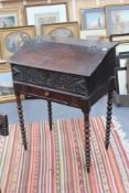 An early 18th Century oak clerk's desk or Bible box, with chip carved top over carved frieze, on