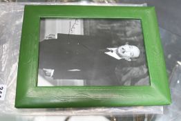 A signed presentation photograph of Anwar Sedat, green leather frame with embossed Egyptian motifs.