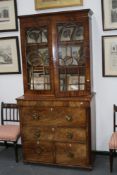 A Regency mahogany secretaire bookcase, with fitted satinwood interior drawers and cellarette