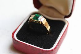 An 18ct gold baguette cut emerald and diamond three stone ring