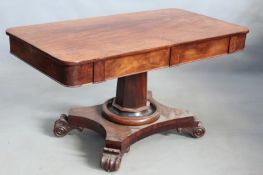 A 19th Century mahogany four drawer library table, on column and platform base with carved scroll