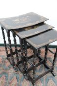 An early Victorian nest of papier mache occasional tables, with hand painted decoration, the tallest