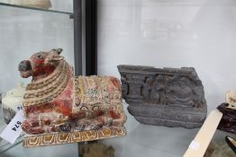 An Indian carved and polychrome figure of a recumbent bull, and a carved figural stone frieze