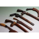 A group of small Malayan sidearms, each with straight edge blade, one with carved horn mounts and