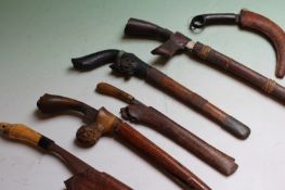 A group of small Malayan sidearms, each with straight edge blade, one with carved horn mounts and