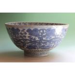 A Chinese blue and white bowl, the interior with cranes near water, the exterior with trailing