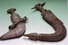 Two Eastern white metal mounted Jambiya, one with script plaque on rear of scabbard
