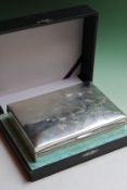 A Japanese silver coloured cigarette box with hardwood interior, the exterior decorated with