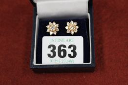 A pair of 18ct gold diamond cluster earrings