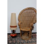 A mid Century cane peacock chair of good size, together with a German pottery floor lamp with