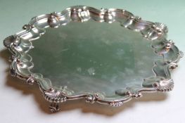 A silver salver, with scalloped rim on three short scrolled feet, Birmingham 1903, Barker