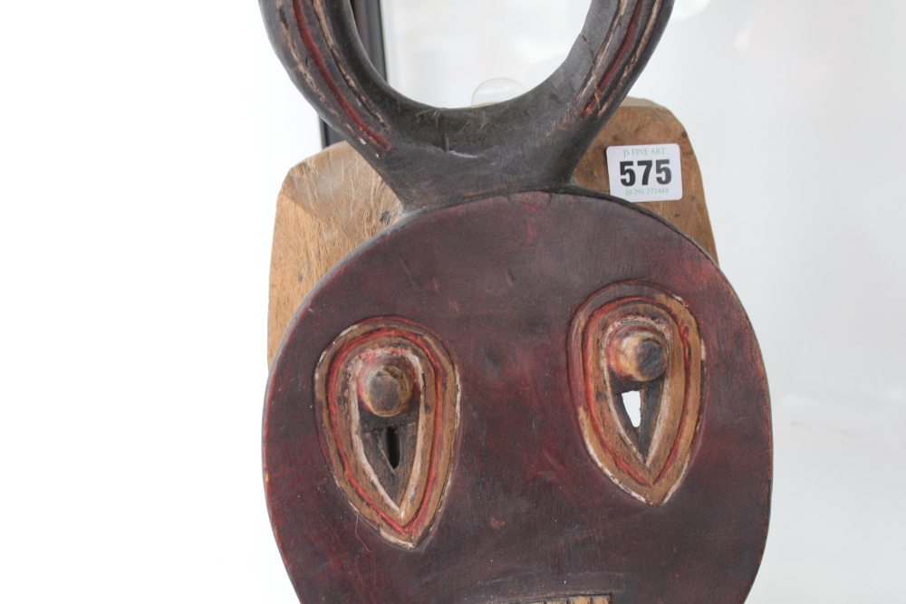 A carved and polychrome tribal ceremonial mask with horn crest, possibly African. - Image 4 of 13