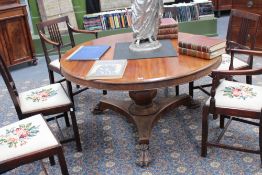 A Victoriaqn carved mahogany tilt top centre table with circular top, triform platform base on paw