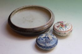 A Chinese blue and white lidded circular box depicting a courtesan in a landscape, 9cm diameter,