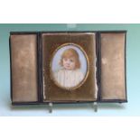 An Edwardian oval miniature portrait of a young girl, signed Viva K Hobson, 7 x 6cm, cased