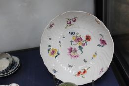 A late 19th Century Meissen dish, the moulded border with summer flowers, 25cm diameter