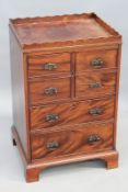 A George III mahogany gallery top nightstand, with faux drawer cupboard over two graduated