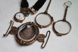 A Victorian gilded oval memorial clasp set with hair, two quizzing glasses, and a bracelet set