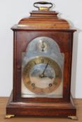 A Georgian style walnut bracket clock with caddy top, the silvered dial with brass chapter ring, 8-