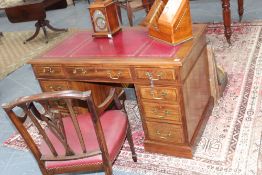 An Edwardian mahogany twin pedestal writing desk, with red leather tooled inset, 122cm x 68cm deep