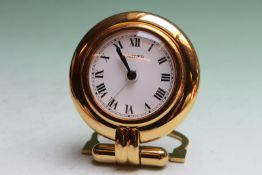 A Cartier round desk clock in brass, 8cm diameter, in Cartier pouch
