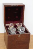 An early 20th Century oak cased four bottle tantalus, containing four cut glass decanters