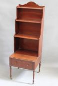 An early 19th Century mahogany waterfall bookcase, with three graduated shelves over single