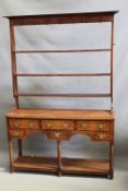 A 19th Century oak small dresser, the open plate rack with iron hooks above three long and three