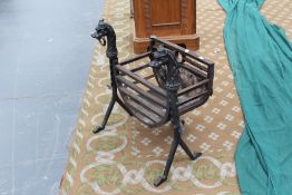 A 19th Century cast iron basket with cast dog and ring finials, 60cm high x 58cm wide