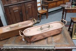 A near pair of antique copper fish kettles, 78cm long