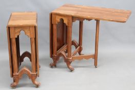 A pair of bespoke walnut and yew wood banded drop leaf side tables, on carved Gothic revival form