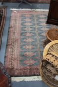 An Oriental rug of Bokhara design and another small rug
