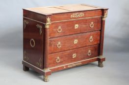 A mahogany ormolu mounted commode in the French Empire style, the column pilasters flanking four