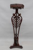 An 18th century Chippendale mahogany kettle stand, with pierced fret gallery to octagonal top and