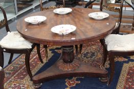 A William IV mahogany tilt top centre table with circular top, triform platform base on bun feet,