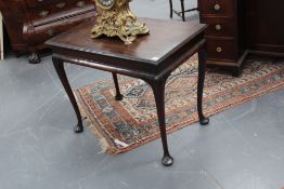 A mahogany Georgian and later centre table, with moulded edge top on four cabriole legs and pad