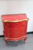 A Continental Rococo style small cabinet, red lacquer with polychrome decoration and frieze drawer