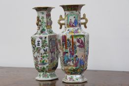 A near pair of Chinese export Cantonese hexagonal twin handle vases, with polychrome figural panels,