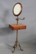 A Victorian brass and mahogany shaving stand, with adjustable height mirror and twin candle