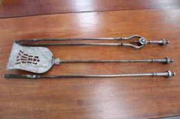 A set of late Georgian steel fire irons (poker 78cm long.)