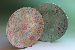 Two Chinese export saucer dishes, with famille rose decoration, 33cm diameter, character marks to