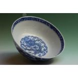 A Chinese blue and white bowl decorated with dragons amidst foliage, 20cm diameter