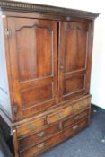 An early oak panelled hanging cupboard, fitted drawers beneath, 135cm wide x 185cm high