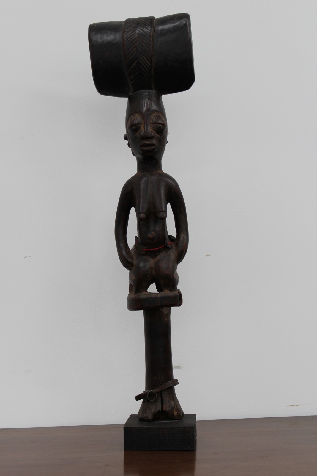 A carved ceremonial tribal staff finial of figural female form, possibly African, 61cm high.