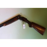 A Laurona 12-bore over and under shotgun, 26inch barrels, border and scroll engraved double