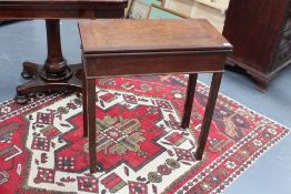 An 18th Century and later Anglo-Chinese foldover tea table, on square section chamfered legs.