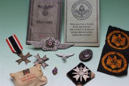 A group of German World War II badges, medals and related ephemera